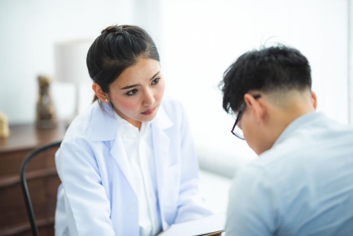 Doctor listening attentively to a patient during a medical consultation about unexplained nerve symptoms